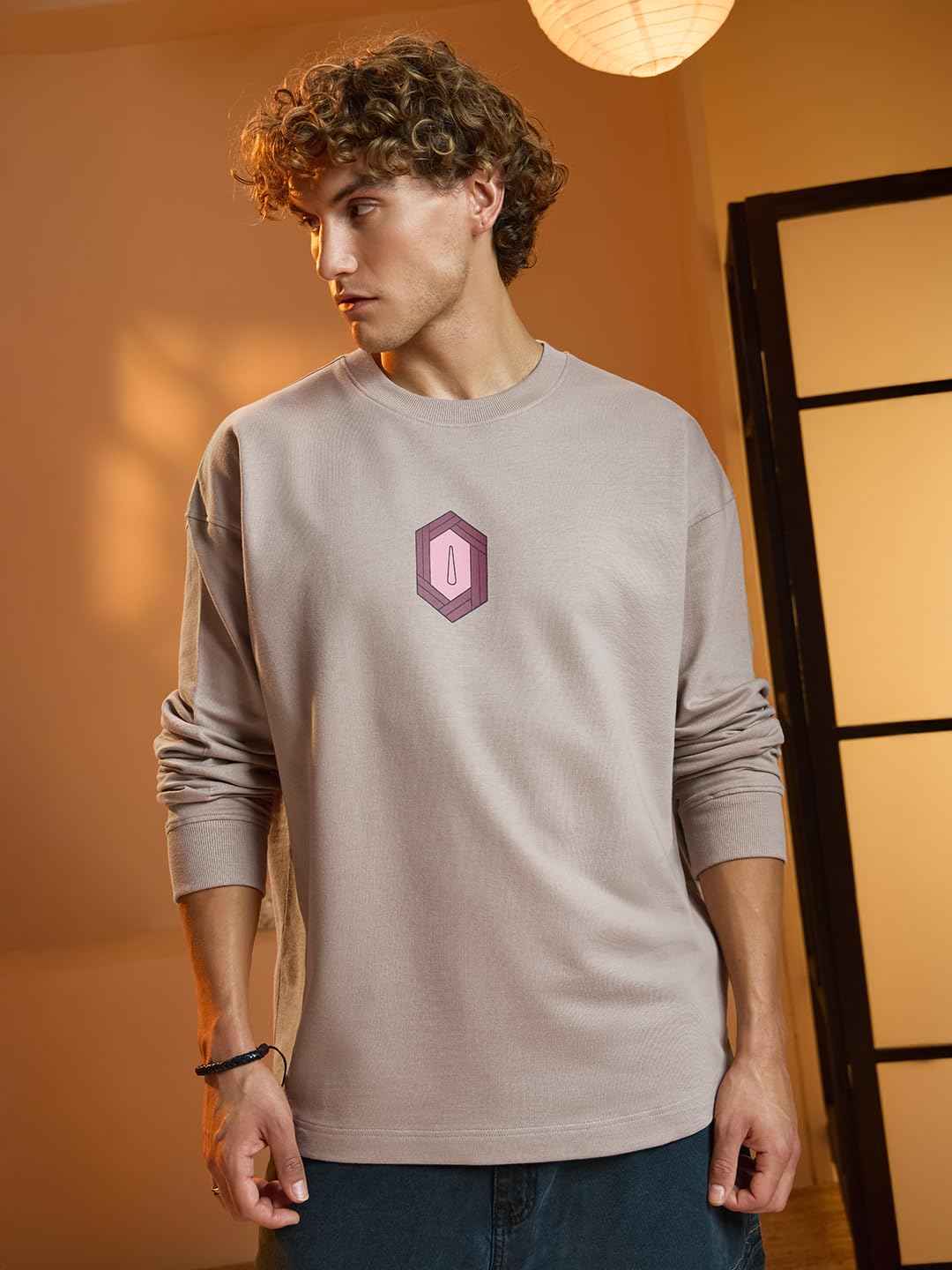 Beige long sleeve Demon Slayer Giyu T-shirt with subtle hexagonal emblem worn by male model