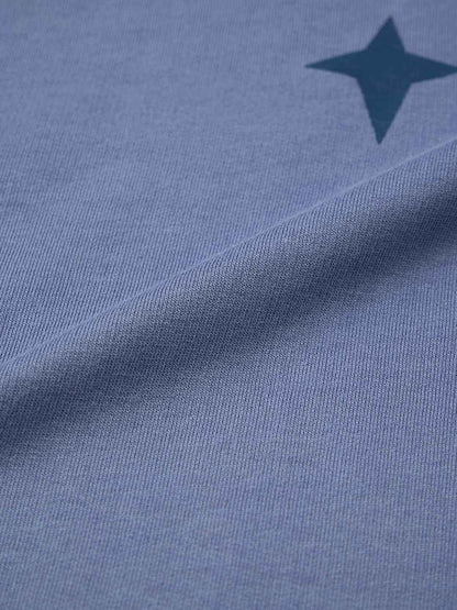 Close-up of blue fabric with a star print detail from Demon Slayer Obanai T-Shirt